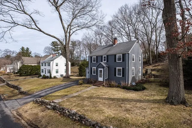 a view of a house with a yard covered in snow