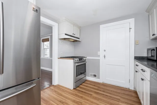 a kitchen with a stove and a refrigerator