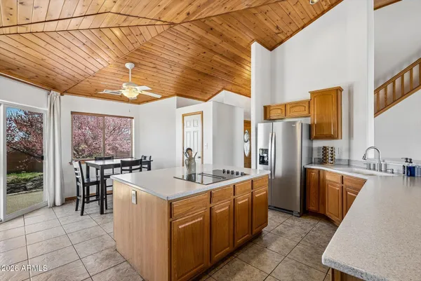 a kitchen with stainless steel appliances granite countertop a sink a stove and a refrigerator