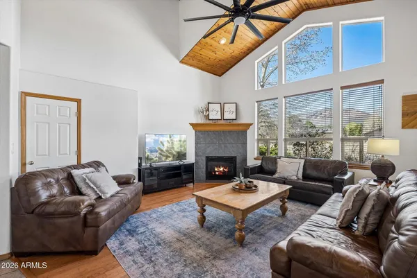a living room with furniture a fireplace and window