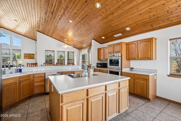 a kitchen with stainless steel appliances granite countertop a sink and dishwasher with a stove top oven