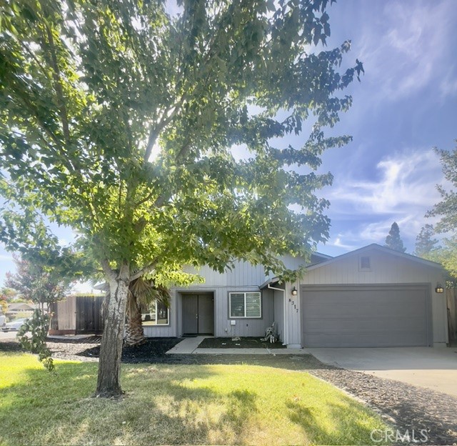 a front view of a house with yard and green space