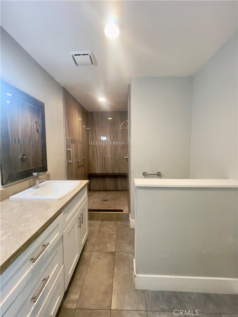8317 Keyesport Way Citrus Heights, CA 95610 - Photo 18 of 28 a spacious bathroom with a granite countertop sink and a mirror
