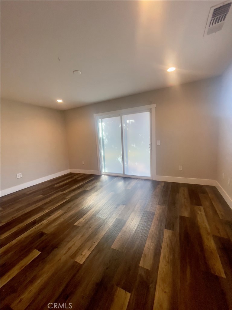 8317 Keyesport Way Citrus Heights, CA 95610 - Photo 22 of 28 an empty room with wooden floor and windows
