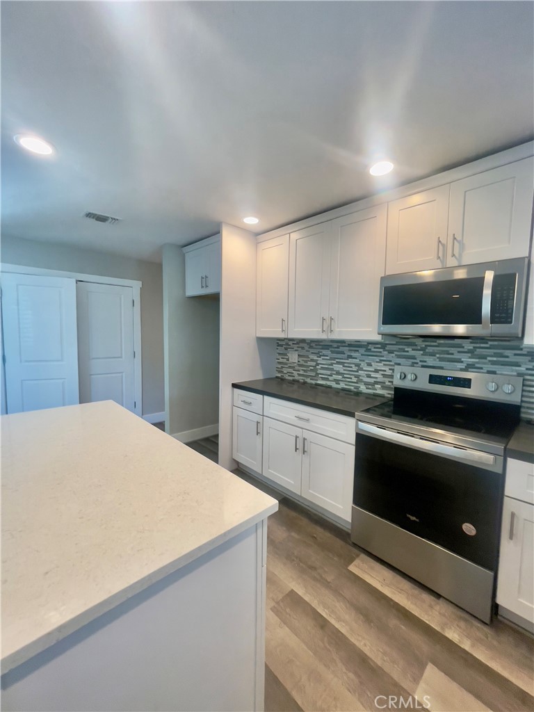 8317 Keyesport Way Citrus Heights, CA 95610 - Photo 7 of 28 a kitchen with stainless steel appliances granite countertop a stove microwave and sink