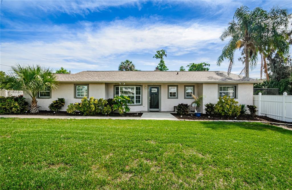 2702 Little Road Valrico, FL 33596 - Photo 1 of 1 a front view of a house with a yard table and chairs