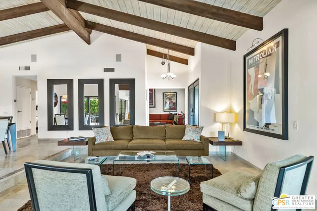 a living room with furniture fireplace and window