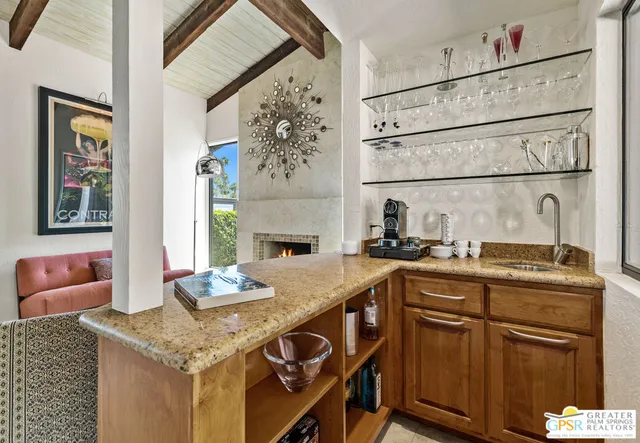 a kitchen with granite countertop a sink stainless steel appliances and cabinets
