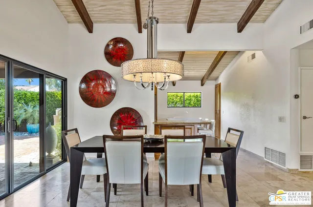 a kitchen with a table chairs stove and cabinets