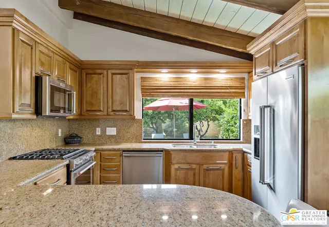 a blue couch sitting in a living room with a baby crib