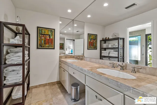 a bedroom with a bed and a lamp