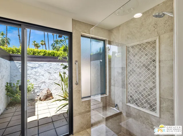 a bathroom with double vanity sink and a mirror