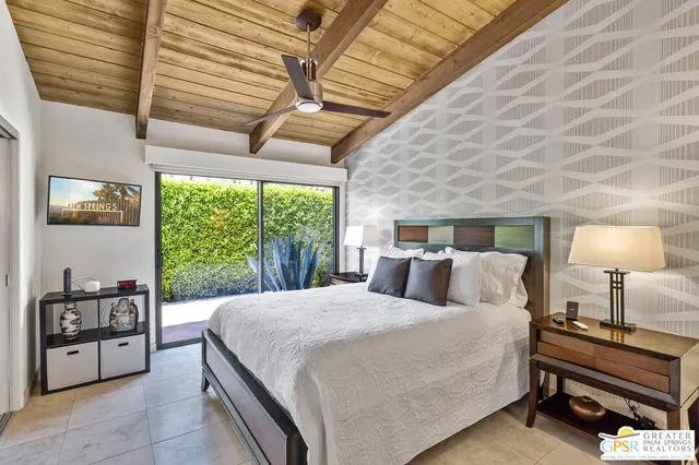 a view of a patio with a table chairs and a umbrella