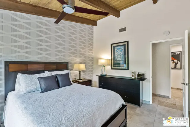 a view of a patio with table and chairs potted plants and palm trees
