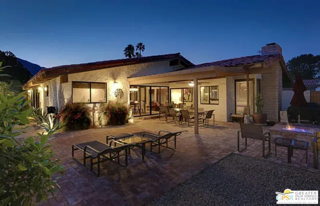a view of a patio with table and chairs and potted plants