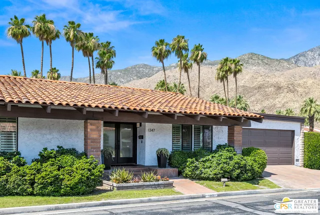 a view of a hallway with wooden floor and a glass door shower
