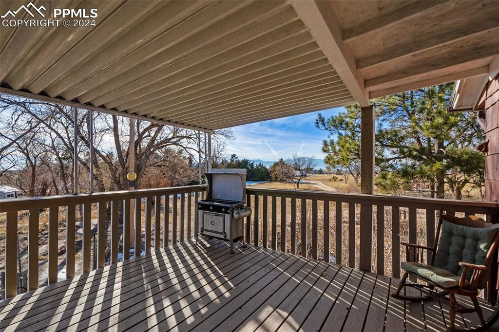 7615 Maverick Road Colorado Springs, CO 80908 - Photo 19 of 42 a view of balcony with wooden floor and outdoor seating