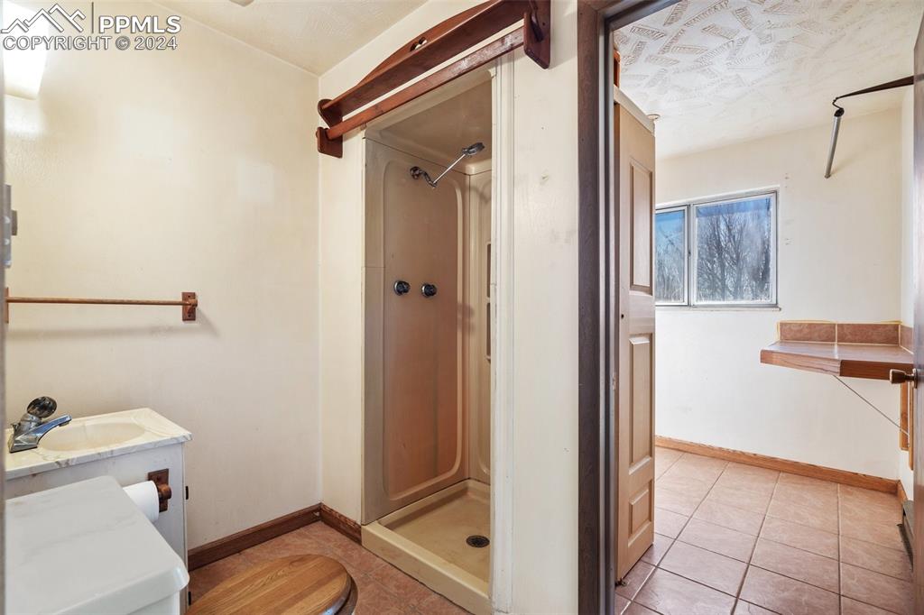 7615 Maverick Road Colorado Springs, CO 80908 - Photo 21 of 42 a bathroom with a sink and toilet
