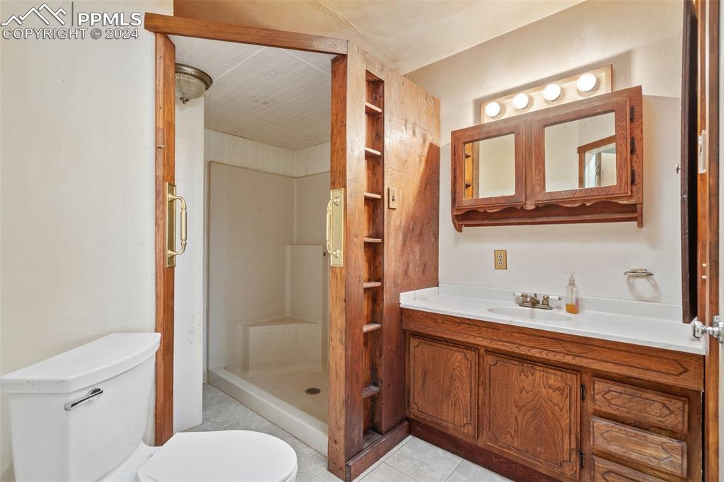 7615 Maverick Road Colorado Springs, CO 80908 - Photo 26 of 42 a bathroom with a sink a toilet and shower