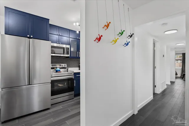 a kitchen with stainless steel appliances a refrigerator and a stove top oven