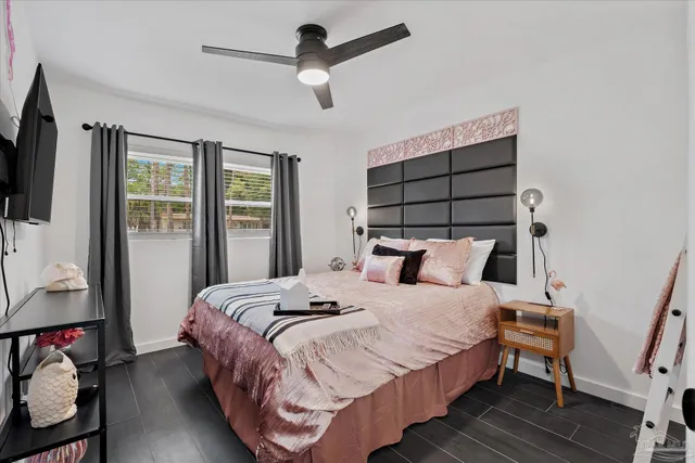 a bedroom with bed and wooden floor