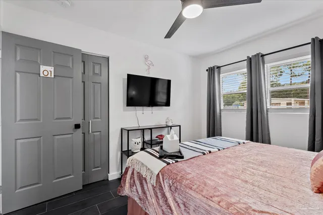 a bedroom with a bed and a flat screen tv