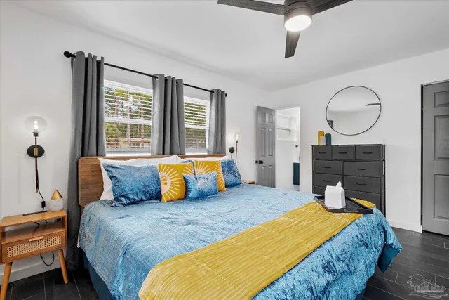 a bedroom with a large bed and a chandelier