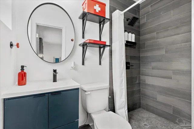 a bathroom with a sink vanity mirror and toilet