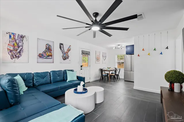a living room with furniture and wooden floor