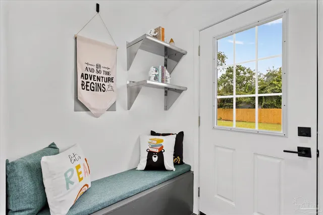 a view of hallway with window and cabinet