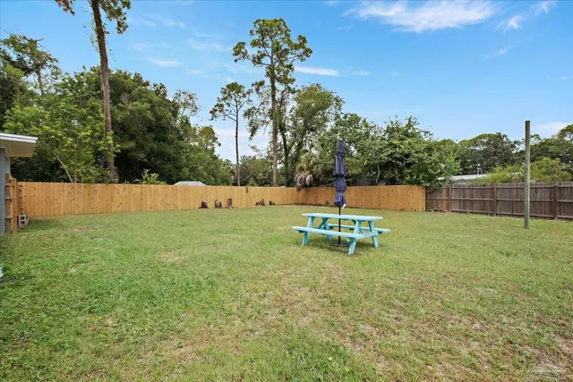 a backyard of a house with table and chairs