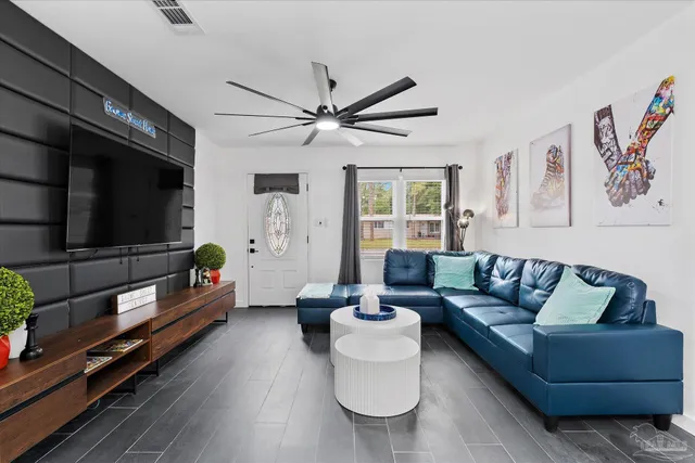 a living room with furniture and a flat screen tv