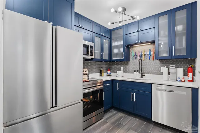 a kitchen with stainless steel appliances granite countertop a refrigerator and a sink