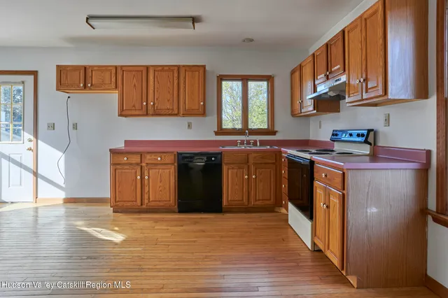 a kitchen with stainless steel appliances granite countertop a stove a sink dishwasher and a microwave oven with cabinets