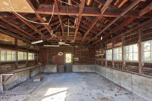 a view of empty room with wooden walls
