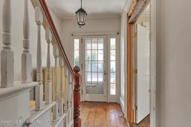 a view of an entryway with wooden floor and stairs