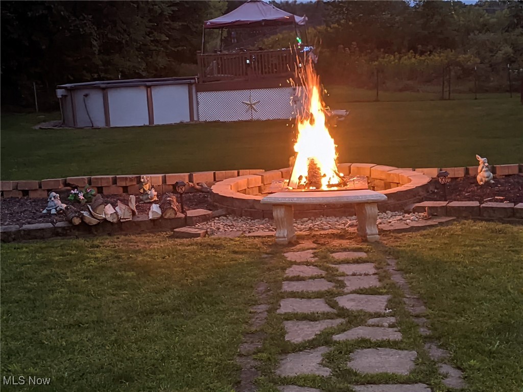 240 Spring Creek Road Northfield, OH 44067 - Photo 39 of 39 View of yard featuring a fire pit and a swimming pool side deck