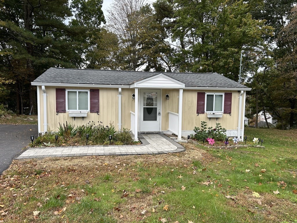 222 Gore Road Webster, MA 01570 - Photo 1 of 32 a front view of house with yard and trees around