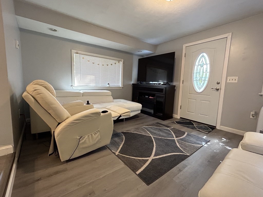 222 Gore Road Webster, MA 01570 - Photo 21 of 32 a living room with furniture a flat screen tv and a window