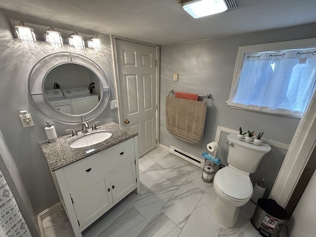 222 Gore Road Webster, MA 01570 - Photo 23 of 32 a bathroom with a toilet sink and mirror