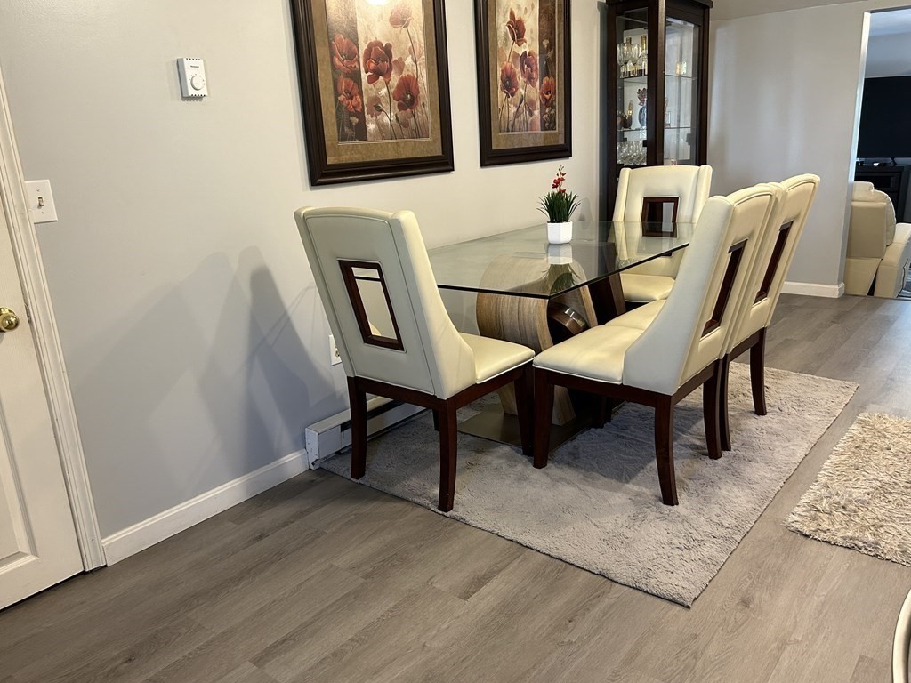 222 Gore Road Webster, MA 01570 - Photo 27 of 32 a view of a dining room with furniture and wooden floor