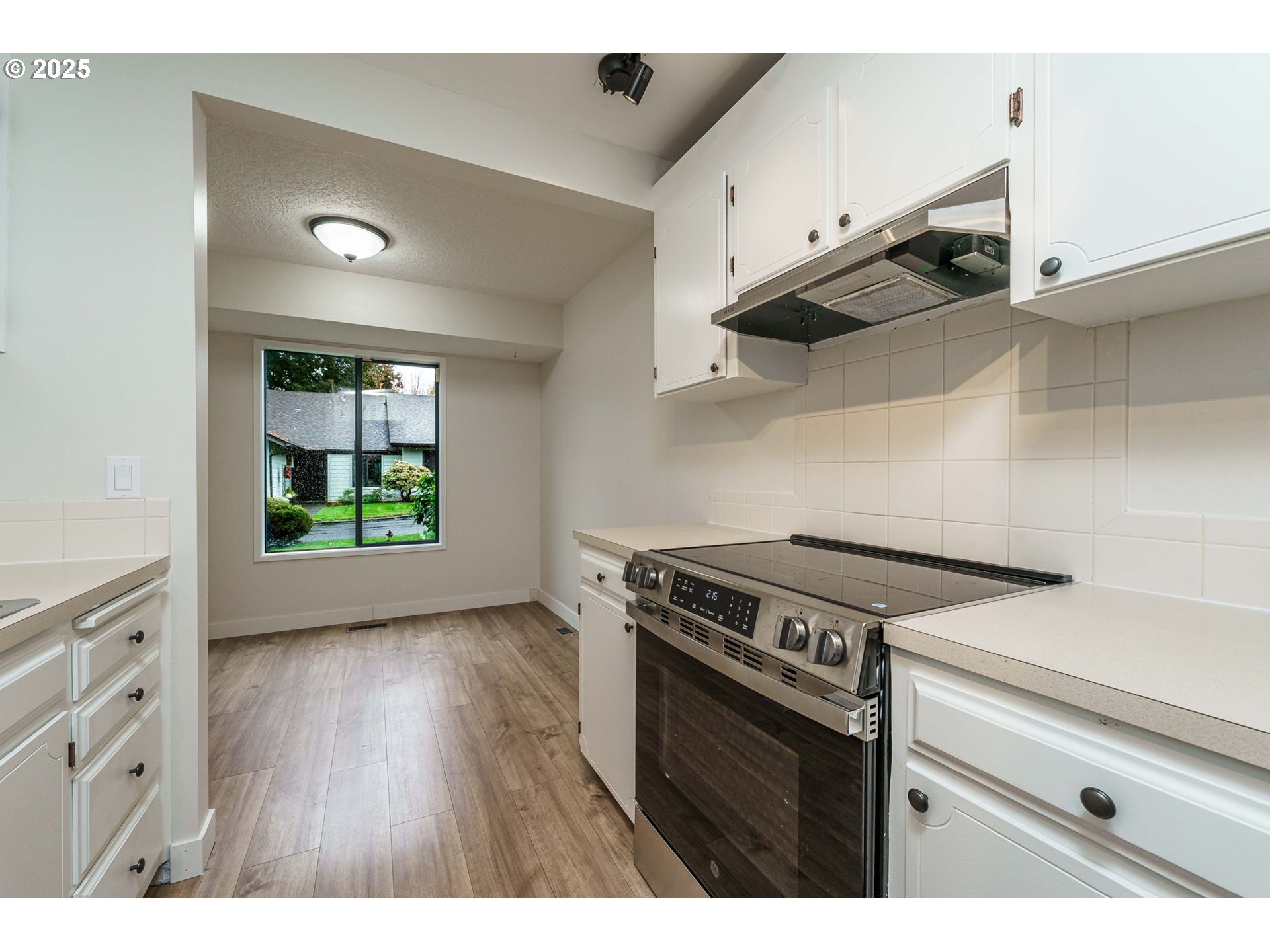 4248 Northeast 125th Place Portland, OR 97230 - Photo 15 of 42 a kitchen with a stove and a wooden floor