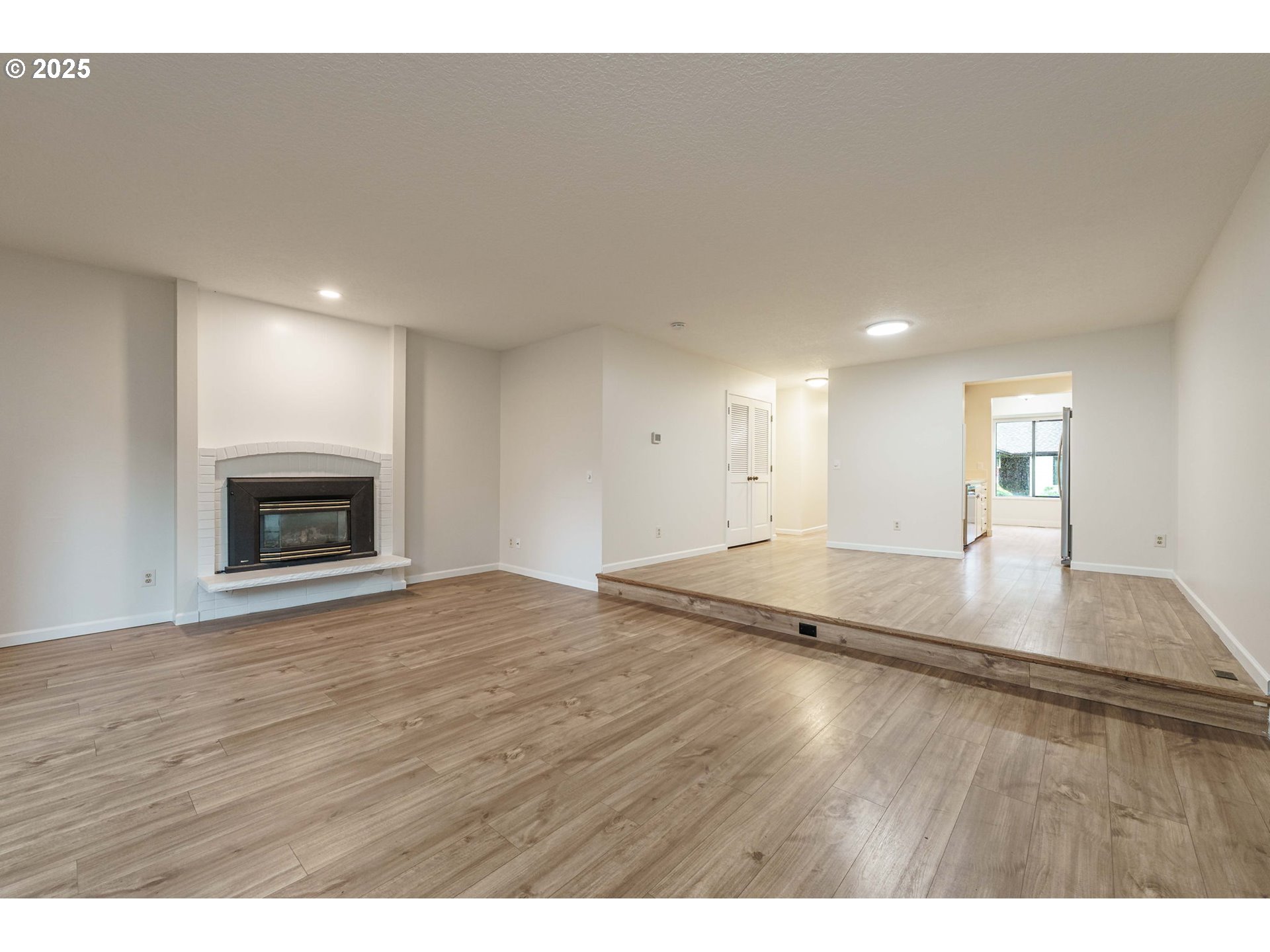 4248 Northeast 125th Place Portland, OR 97230 - Photo 9 of 42 a view of empty room with wooden floor and fireplace