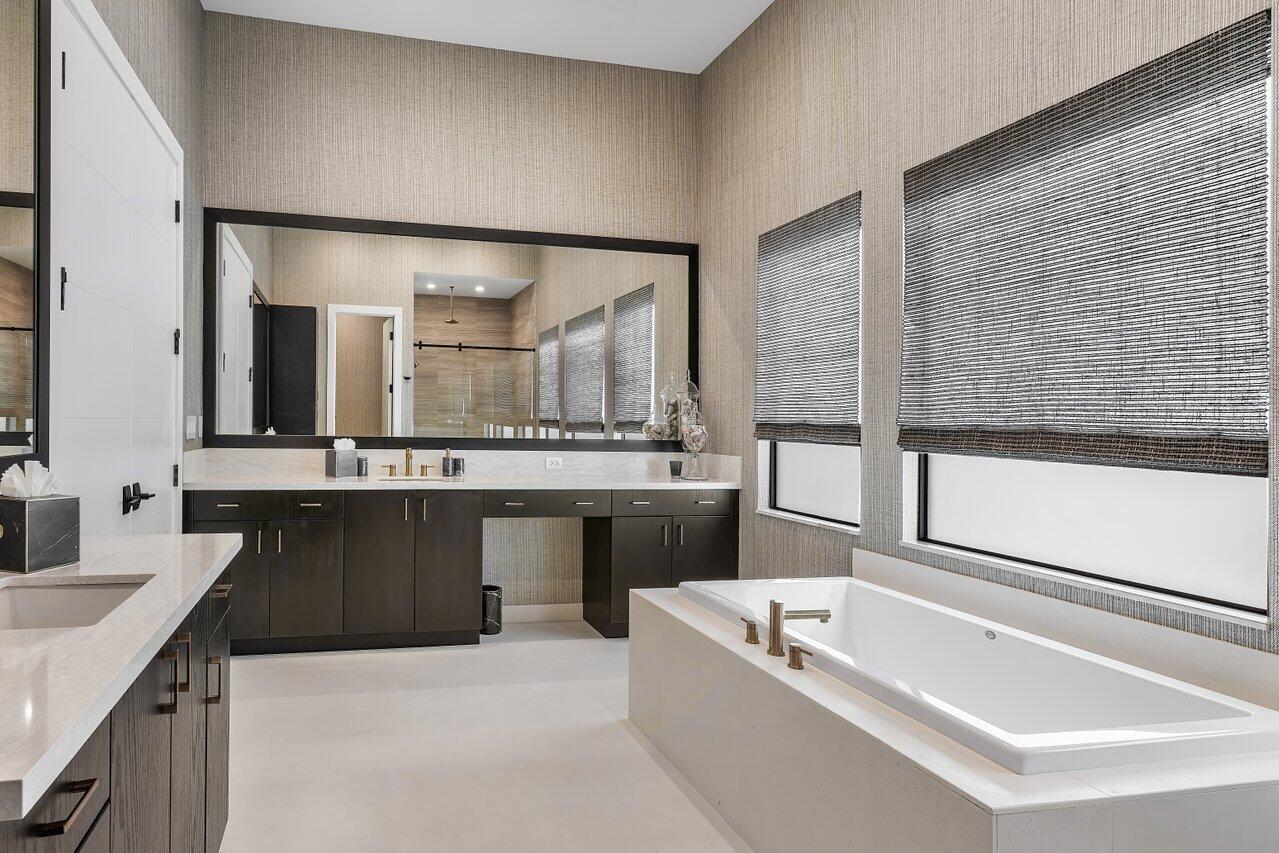 9109 Fiano Place Boca Raton, FL 33496 - Photo 12 of 24 a bathroom with a bathtub a double vanity sink and mirror