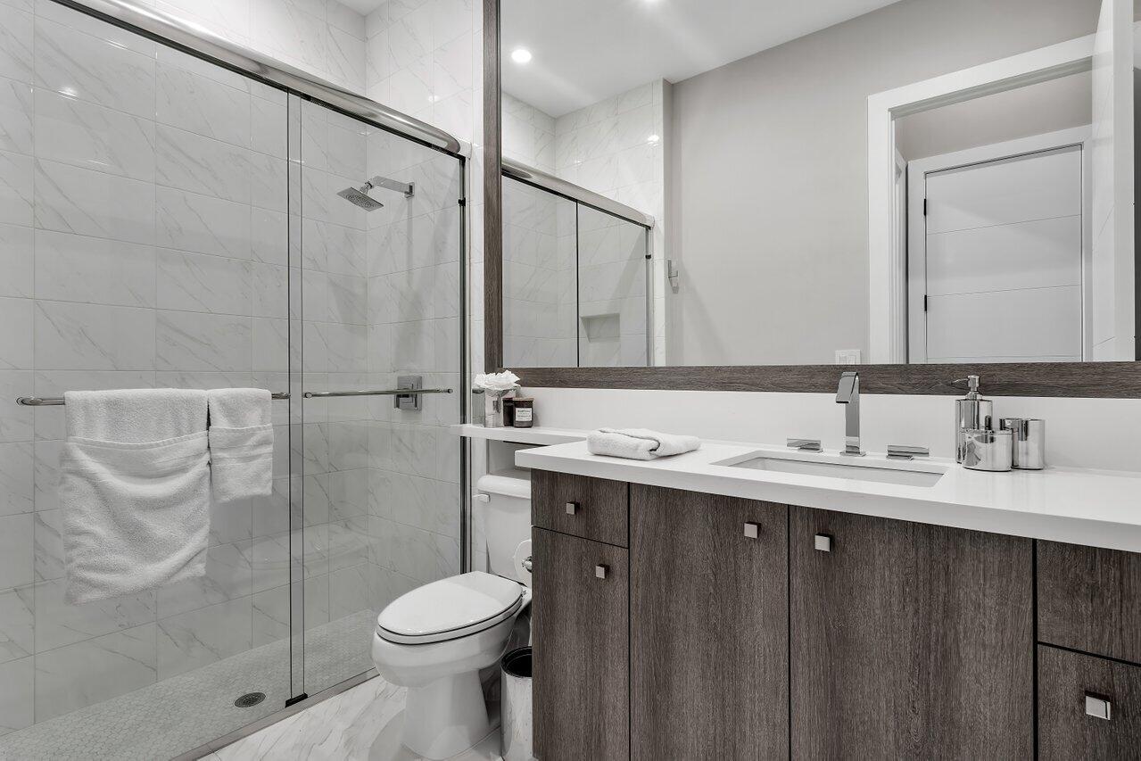 9109 Fiano Place Boca Raton, FL 33496 - Photo 16 of 24 a bathroom with a sink toilet and shower