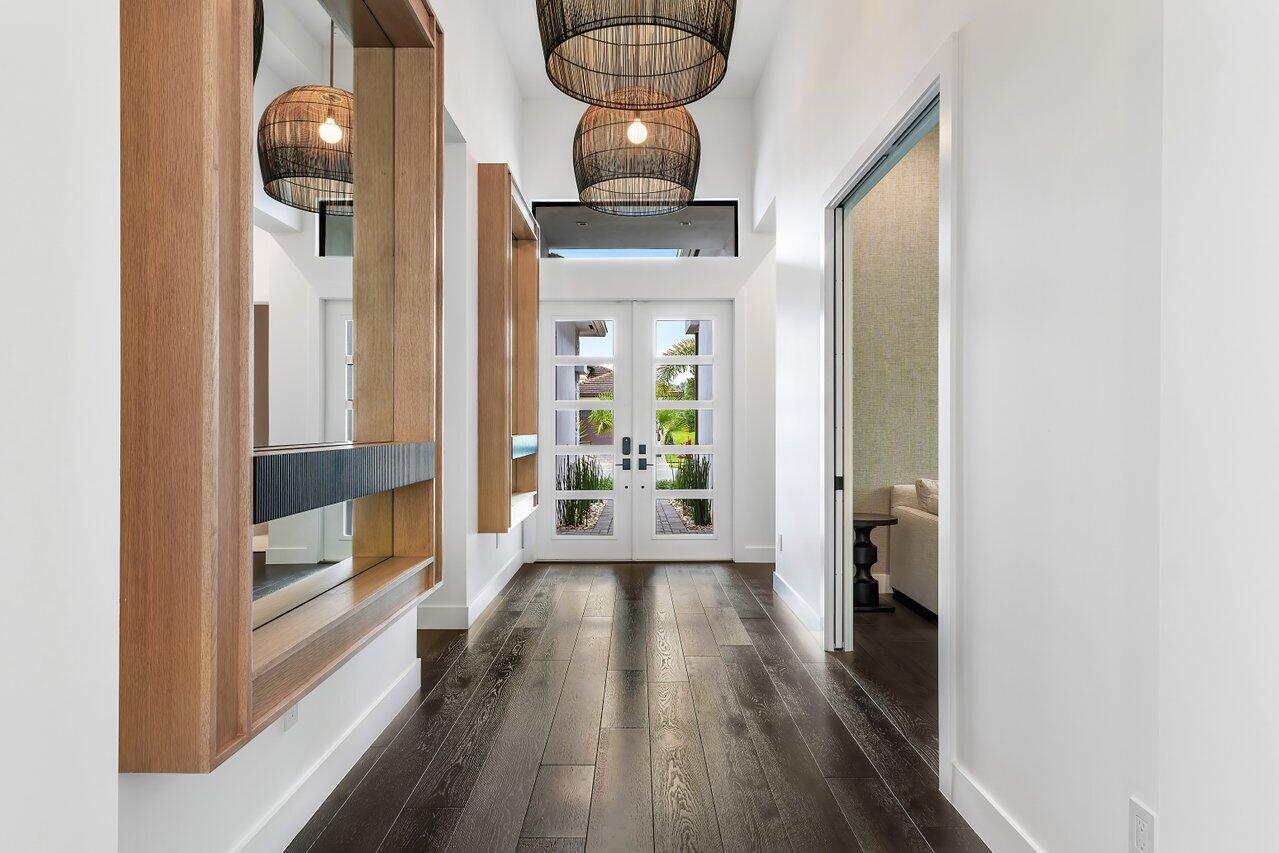 9109 Fiano Place Boca Raton, FL 33496 - Photo 2 of 24 a view of a hallway view with wooden floor and staircase