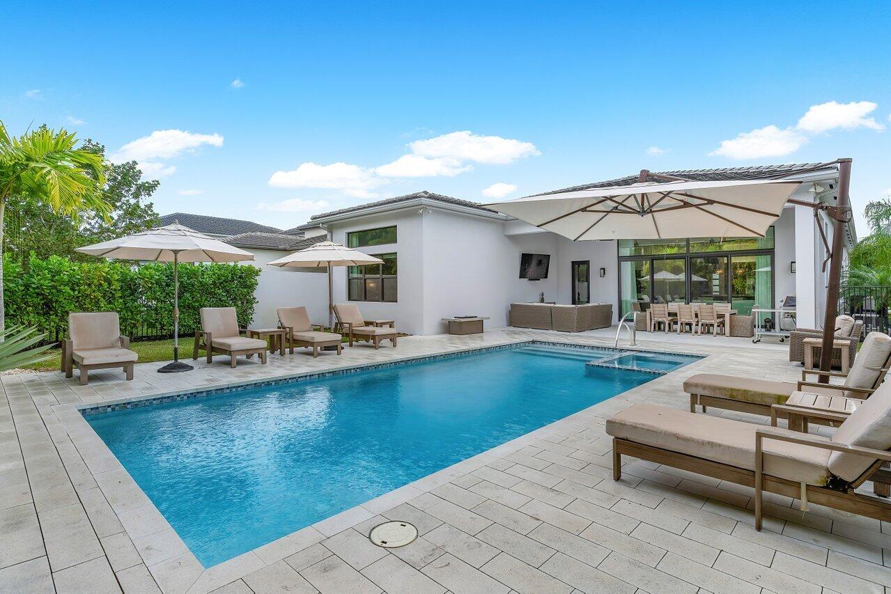 9109 Fiano Place Boca Raton, FL 33496 - Photo 21 of 24 a view of a patio with swimming pool table and chairs