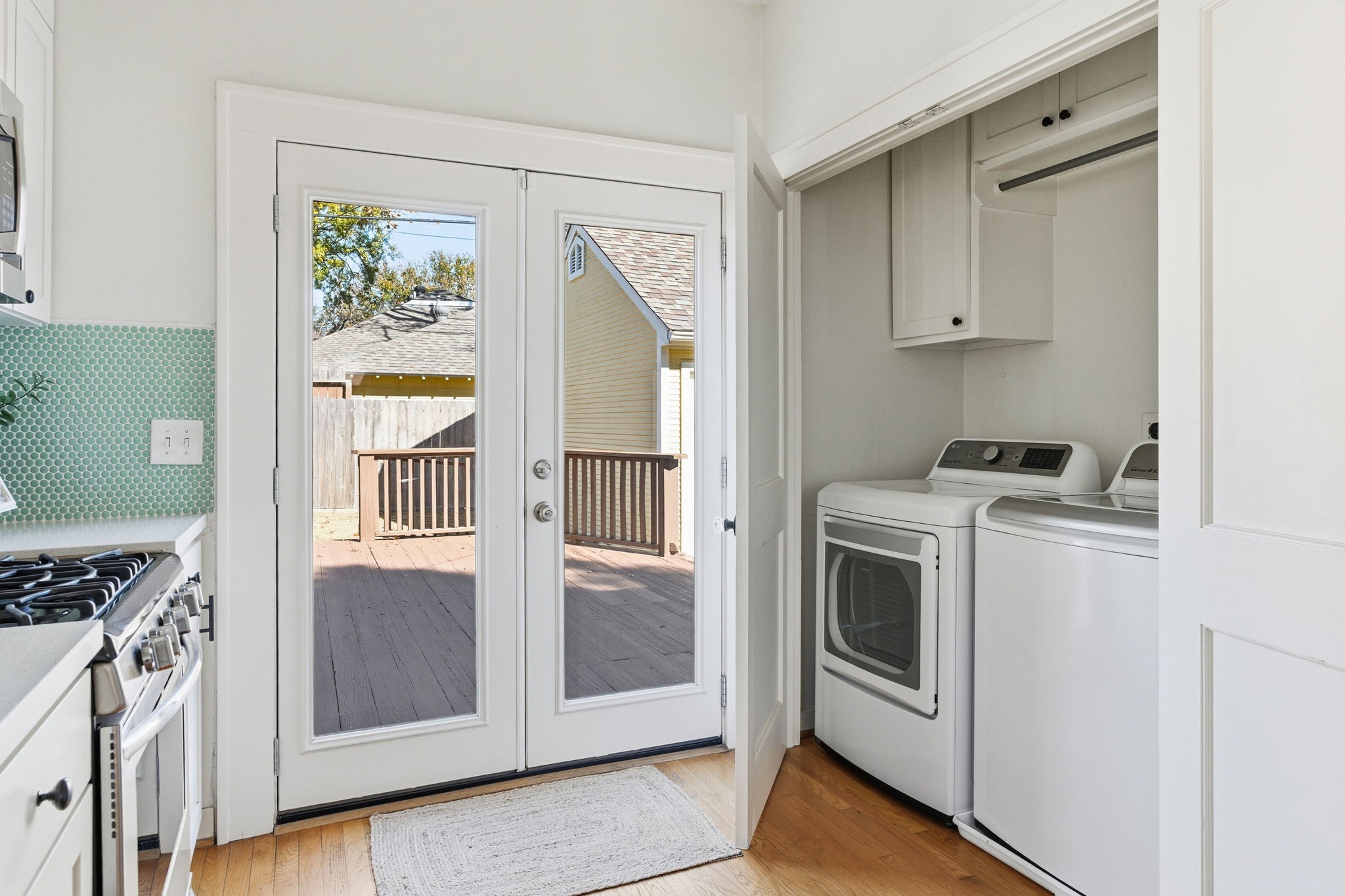 1103 Key Street Houston, TX 77009 - Photo 11 of 35 Convenient and compact laundry space with a washer and dryer, neatly tucked behind double doors.