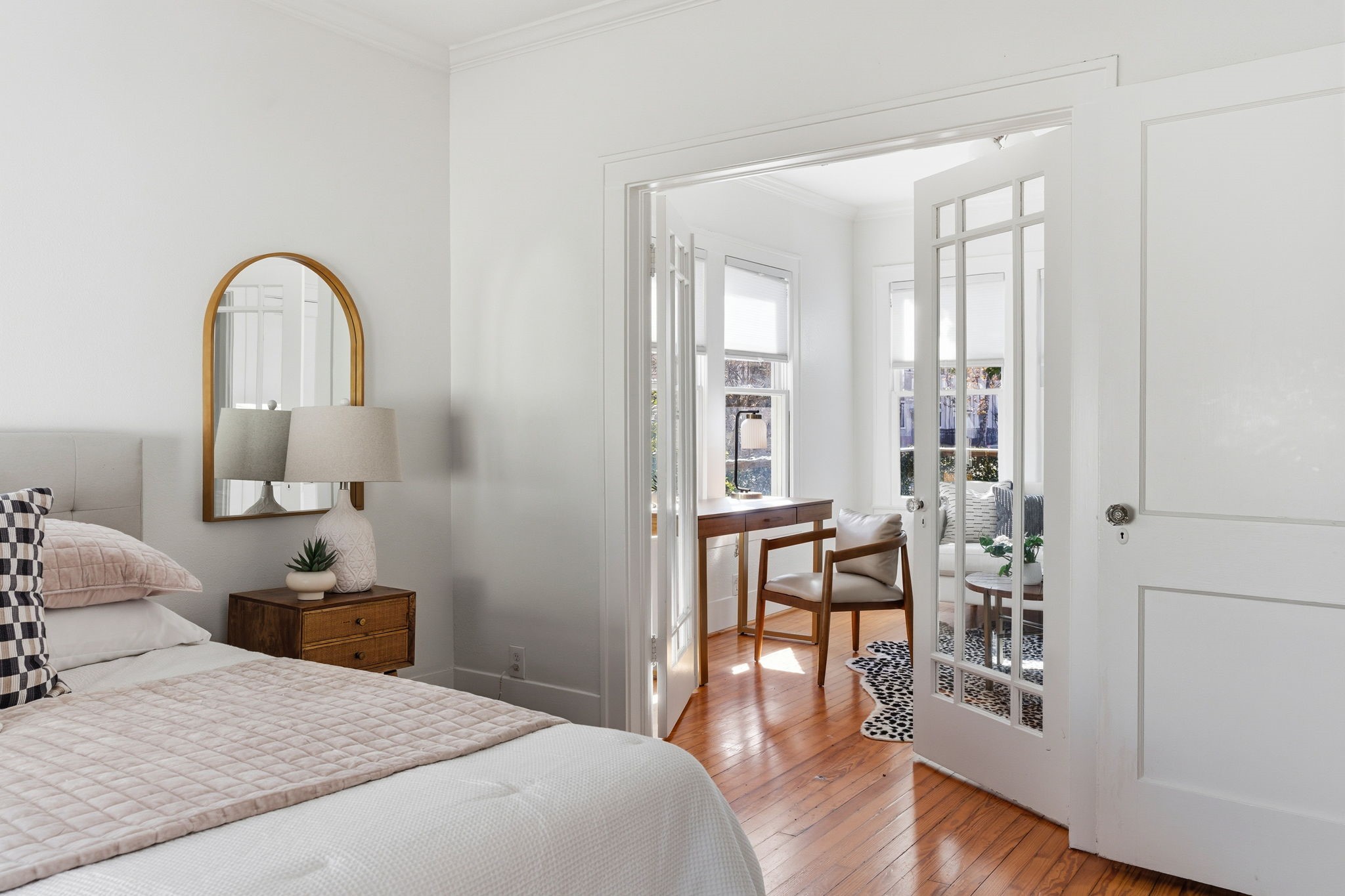 1103 Key Street Houston, TX 77009 - Photo 14 of 35 French doors open to a bright sitting area with large windows, providing natural light and a serene view. Perfect for relaxation or reading.