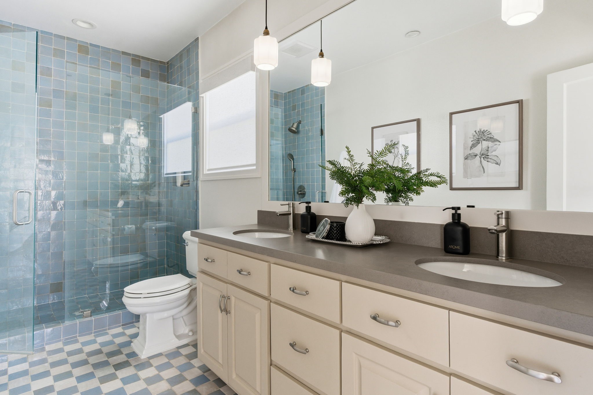 1103 Key Street Houston, TX 77009 - Photo 16 of 35 Primary bathroom with a spacious layout with a double vanity, modern fixtures, and ample storage. It includes a glass-enclosed shower with elegant blue tiles and a sleek, contemporary design.